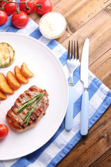 Grilled steak, grilled vegetables and fried potato pieces