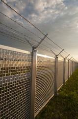 barbed wire at metal fence