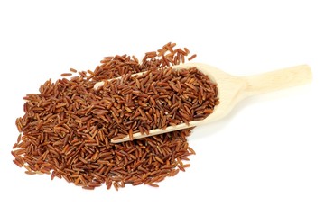 Roter Reis mit Holzlöffel isoliert auf weißem Hintergrund