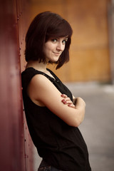 Beautiful brunette next to a red wall