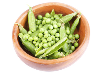 Fresh green peas in wooden bowl, isolated on white background