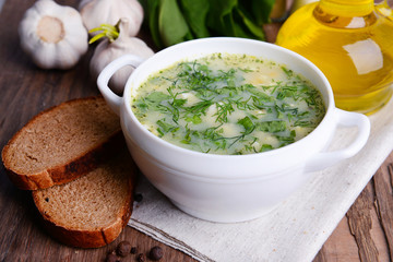 Delicious green soup with sorrel on table close-up