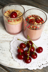 Tasty cherry dessert on wooden table