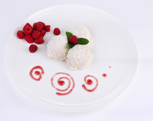 Creamy ice cream with raspberries on plate, isolated on white