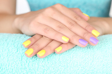 Obraz na płótnie Canvas Female hand with stylish colorful nails,