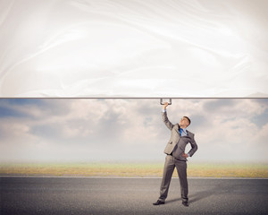 businessman holding a banner with one hand