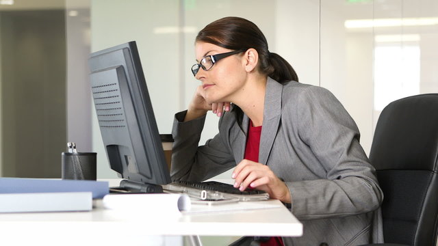 Young businesswoman working on computer at desk