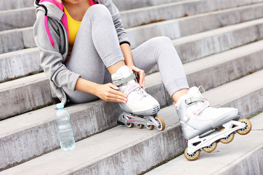 Woman putting on roller-blades