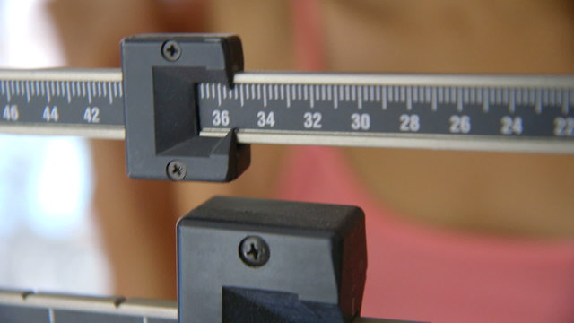 Close up of hand adjusting scale