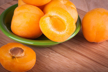 Fresh and ripe apricot on a wooden background