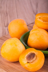 Fresh and ripe apricot on a wooden background