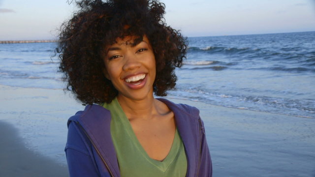 Portrait of woman having fun and smiling at beach