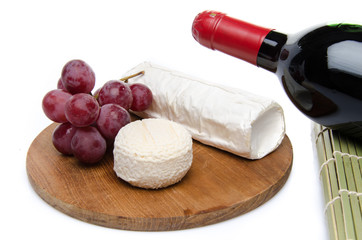 Composition of goat cheese on a wooden cutting board