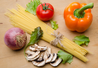 Composition of uncooked spaghetti surrounded by different types