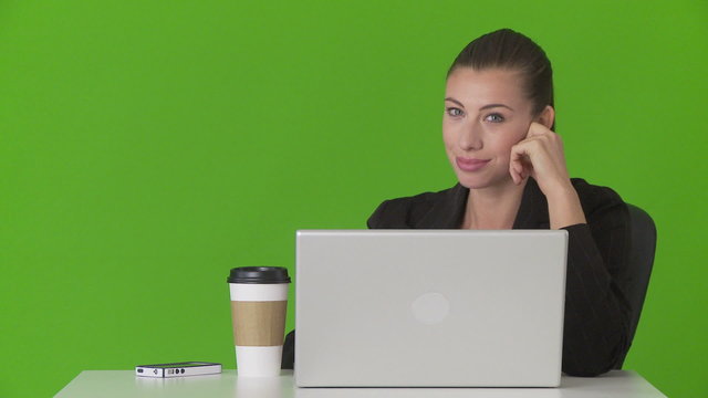 Portrait of young businesswoman  at desk with cellphone and lapt