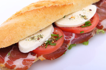 Sandwich with ham, mozzarella and tomato