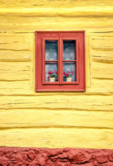 Close-up detail of colorful window on wooden cottage
