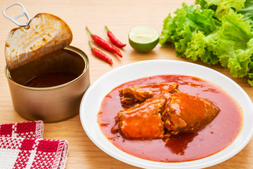 Canned fish in tomato sauce on plate