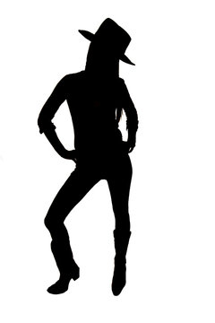 Silhouette of cowgirl with a hat standing up