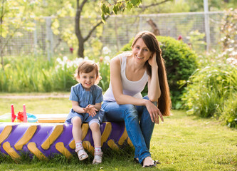 Fototapeta premium Happy mother and little daughter on nature