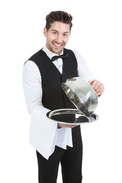 Butler Lifting Cloche From Serving Tray