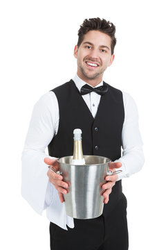 Waiter Holding Ice Bucket With Champagne Bottle