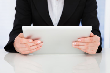 Businesswoman Holding Digital Tablet At Desk