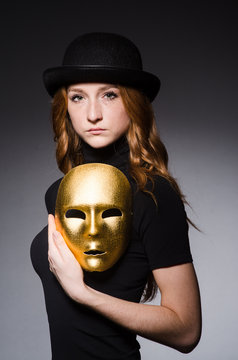 Redhead woman in hat  iwith mask in hypocrisy consept against gr