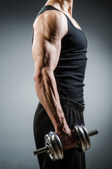 Muscular ripped bodybuilder with dumbbells