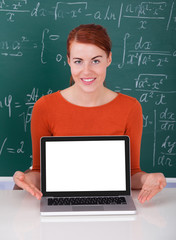 Student Presenting Laptop In Classroom