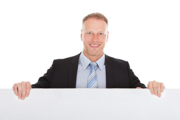 Confident Businessman Showing Billboard