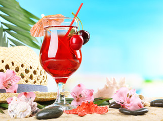 Refreshing cherry cocktail on sand beach