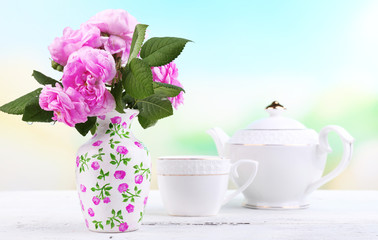 Breakfast tea with  teapot of fresh pink garden roses