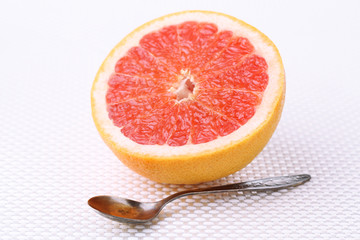 Half of grapefruit on light background