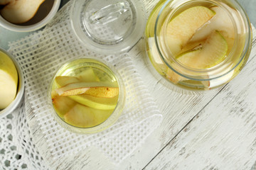 Sangria drink in glass and jar on wooden background