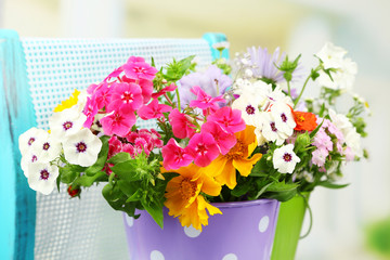 Obraz na płótnie Canvas Bouquet of colorful flowers in decorative buckets,