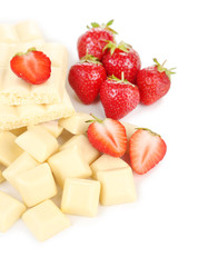 White chopped chocolate bar with fresh strawberries, isolated