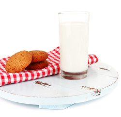 Milk and cookies on wooden tray isolated on white