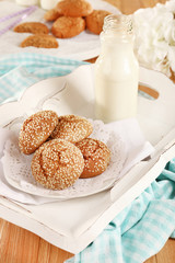 Milk and cookies on tray on table