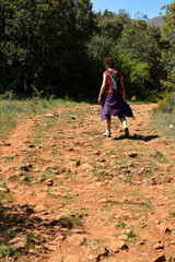 mujer caminando por un camino empedrado