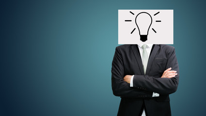 Businessman standing white paper ideas face holding front of hea