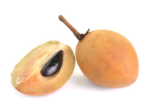 Whole and partial fresh sapodilla isolated on white background