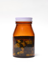 group of green capsule medicine in bottle