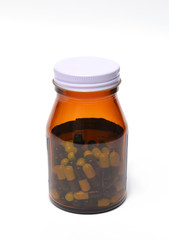 group of green capsule medicine in bottle