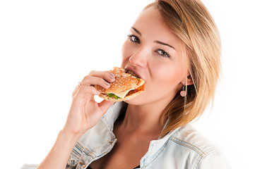 fashionable young woman eating a hamburger isolated on white