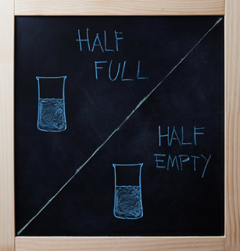 Half Full And Half Empty Concept Drawn On Blackboard