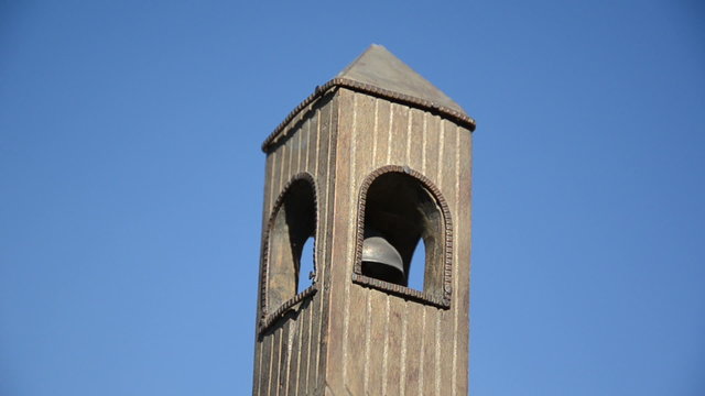 Wooden belfry toy imitation with bell jingle sound on blue sky