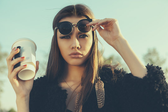 Beautiful hipster woman with cup of coffee