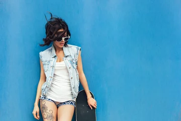 Foto auf Acrylglas Young brunette woman posing with skateboard © Kaponia Aliaksei