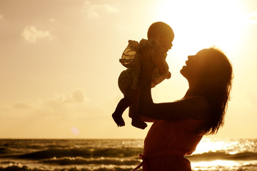 Portrait of happy loving mother and her baby outdoors - 66570663